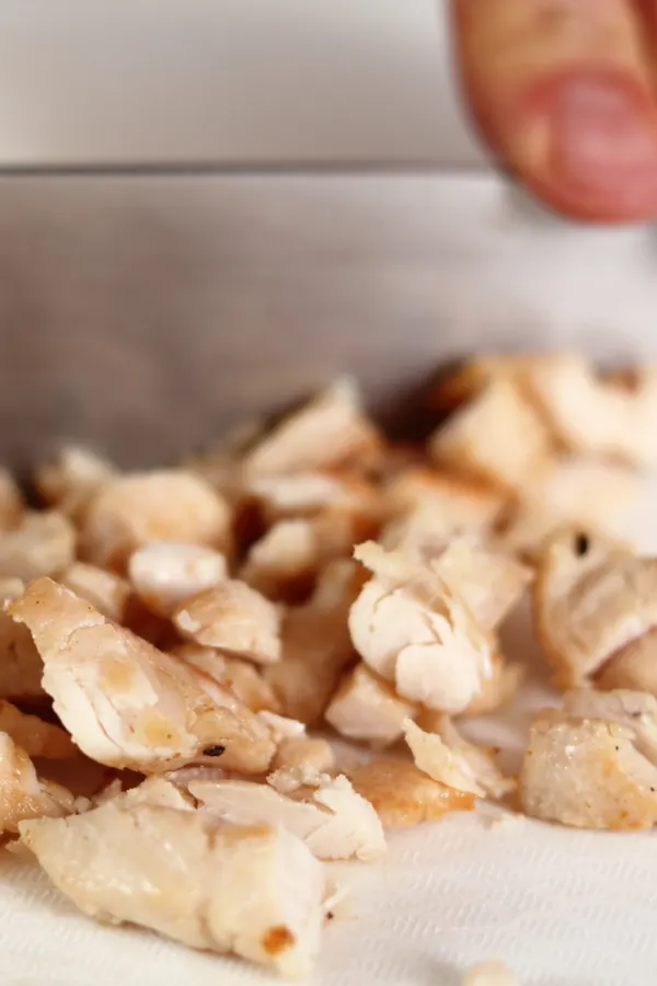 cooked chicken being diced