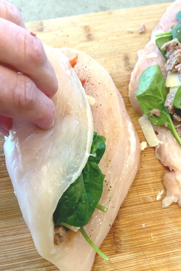 rolling the chicken breast