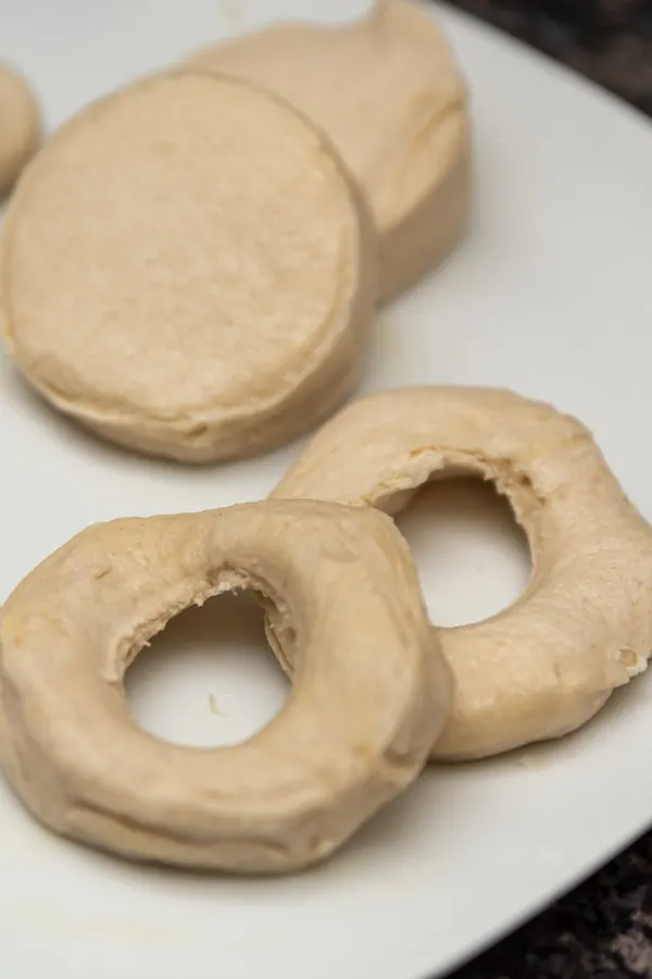 cutting a hole out of the center of biscuit dough
