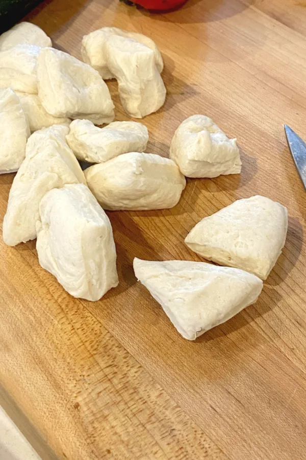 biscuit dough cut in quarters