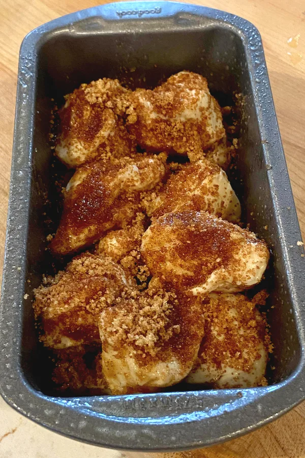 mini loaf pan with cut biscuits and cinnamon sugar