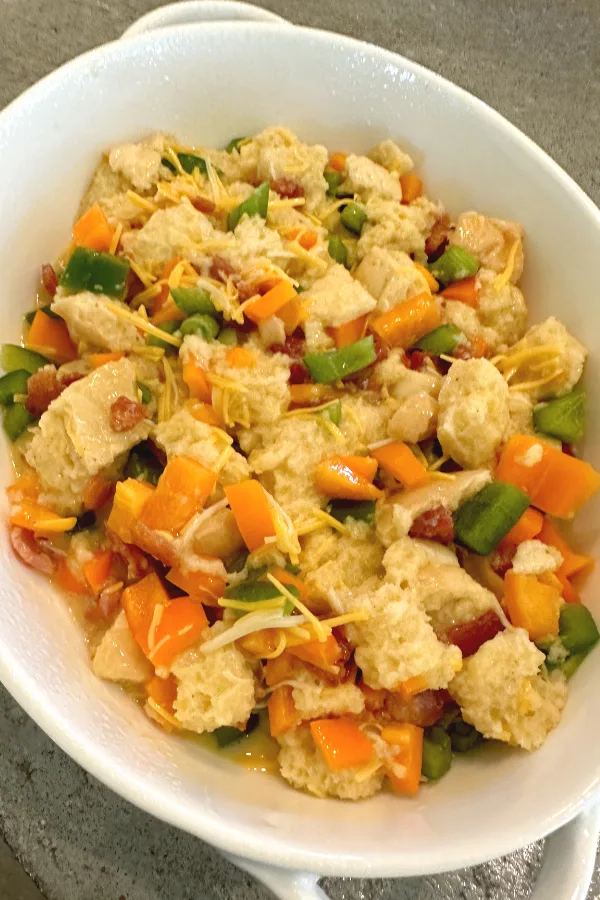 overnight breakfast casserole in a white oval dish 