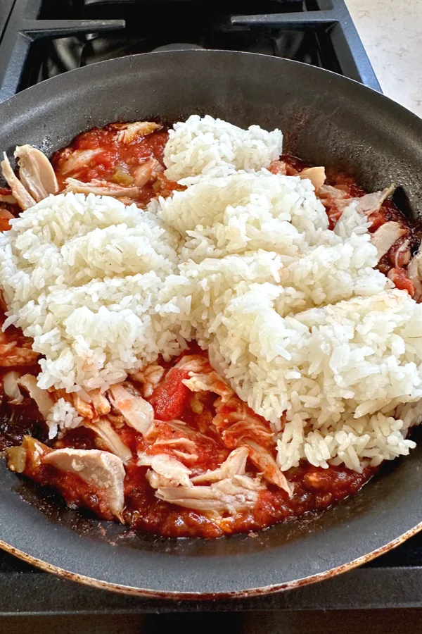 rice in skillet with tomatoes