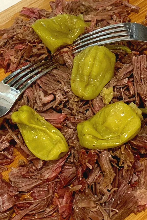 shredding roast with two forks