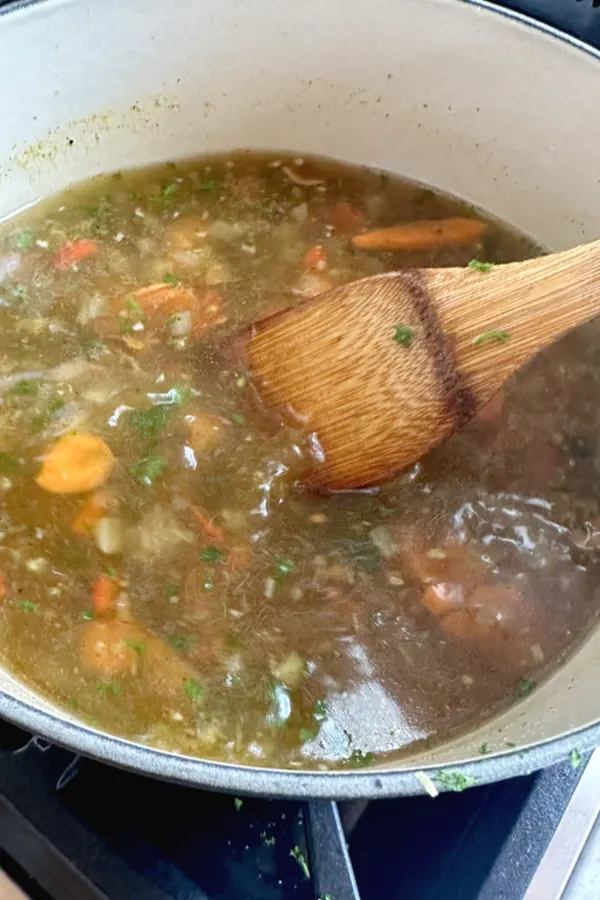 soup with vegetables being stirred 