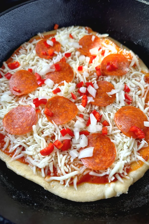 toppings of pepperoni, cheese, diced peppers and diced onions