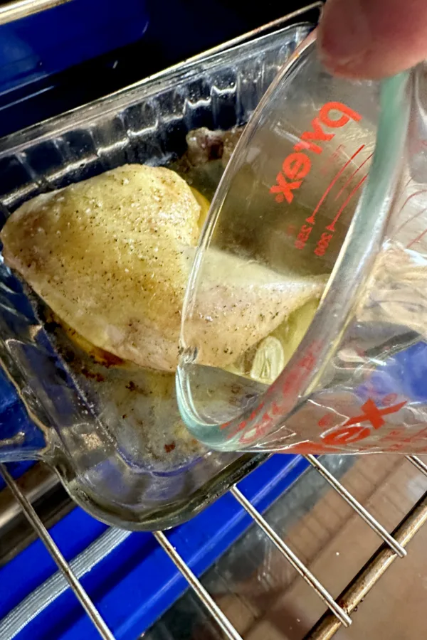 pouring white wine in baking dish