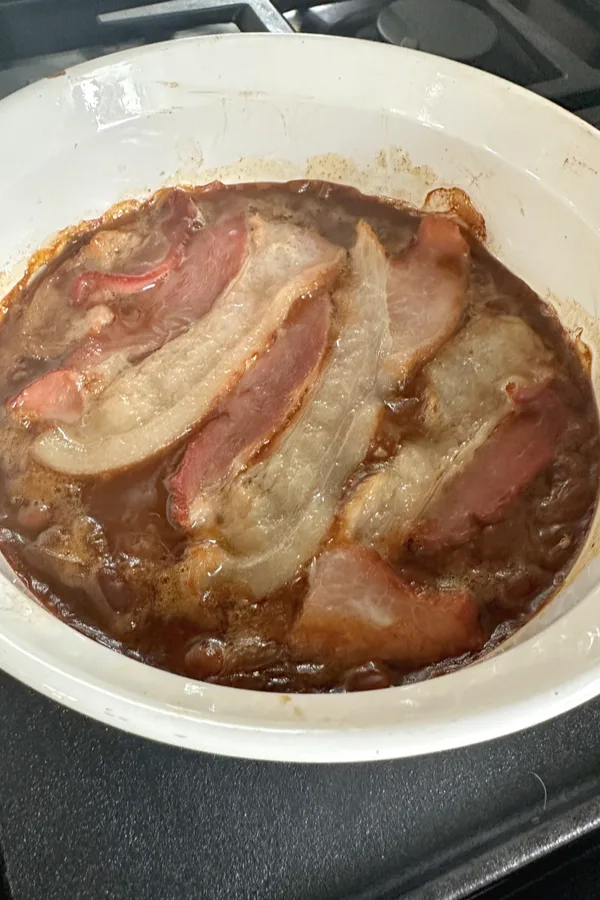 bacon strips on saucy beans 