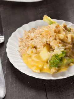 A serving of Chicken Divan for two on a white plate with a fork next to it.