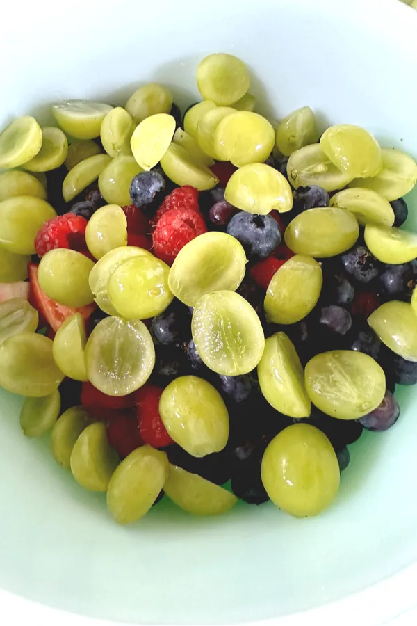 grapes blueberries strawberries and raspberries in a bowl