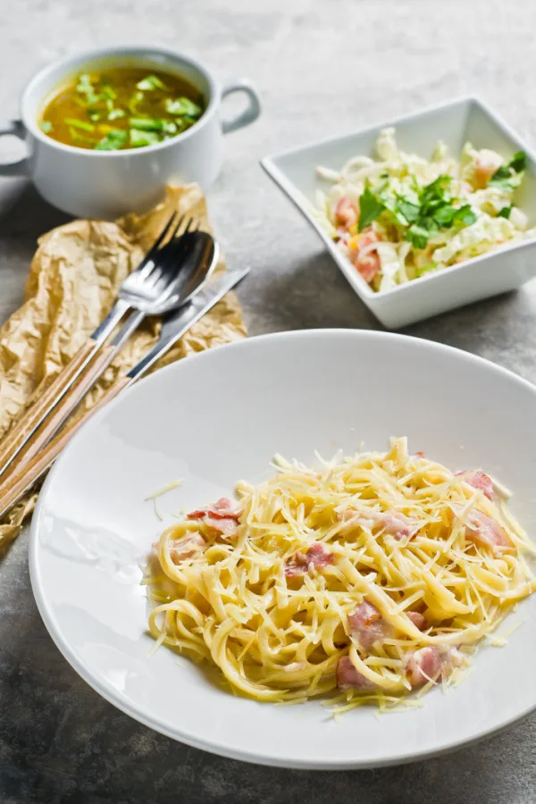 spaghetti with soup and salad