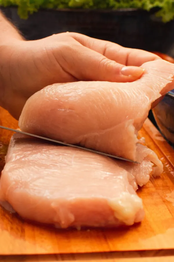 cutting chicken into two pieces