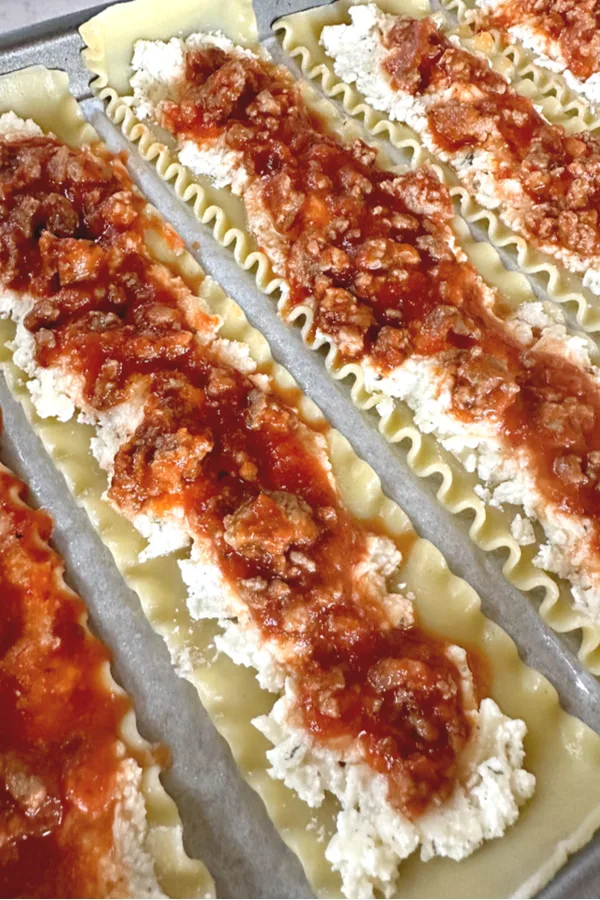 meat and cheese filling on pasta noodles