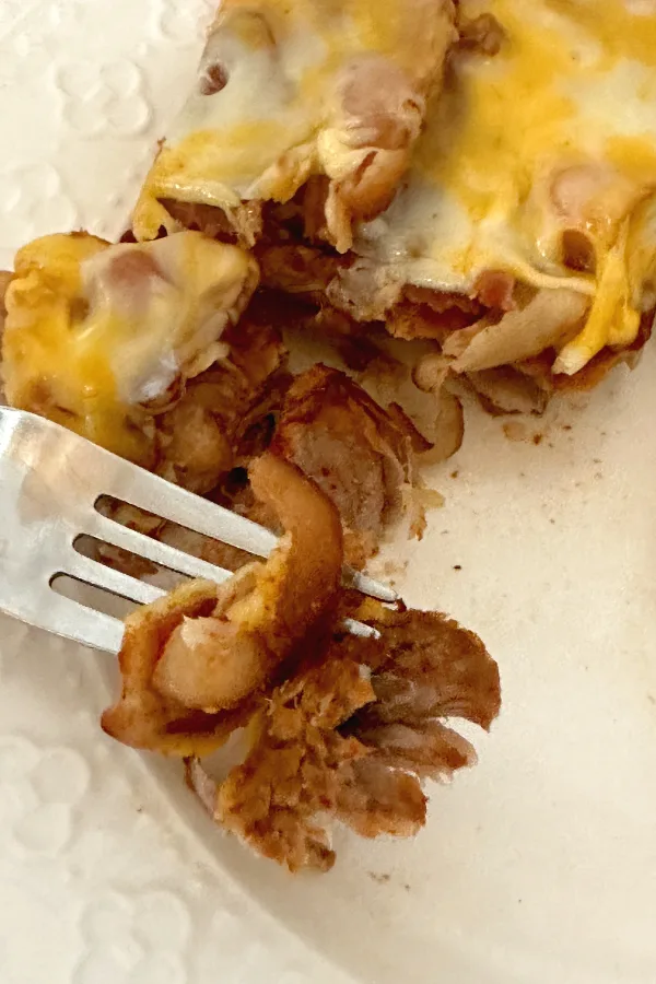 fork with a bite of pork chop