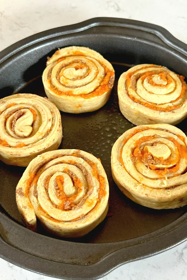pumpkin puree inside rolled cinnamon rolls