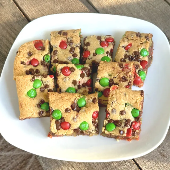 M&M Cookie bars on a plate and ready to be eaten.