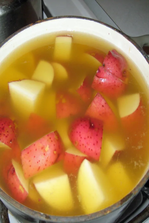 red skin potatoes boiling in a pot.