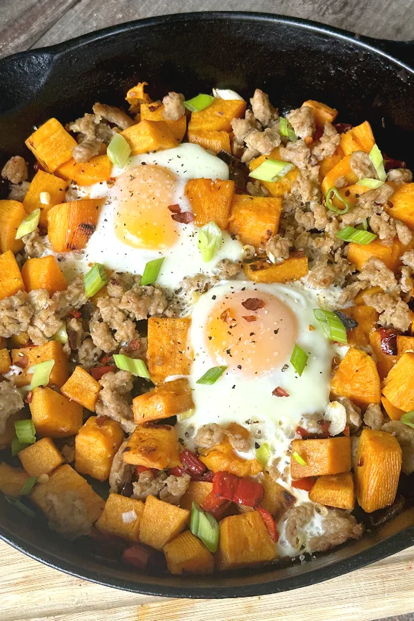 sweet potato sausage hash with 2 eggs on top