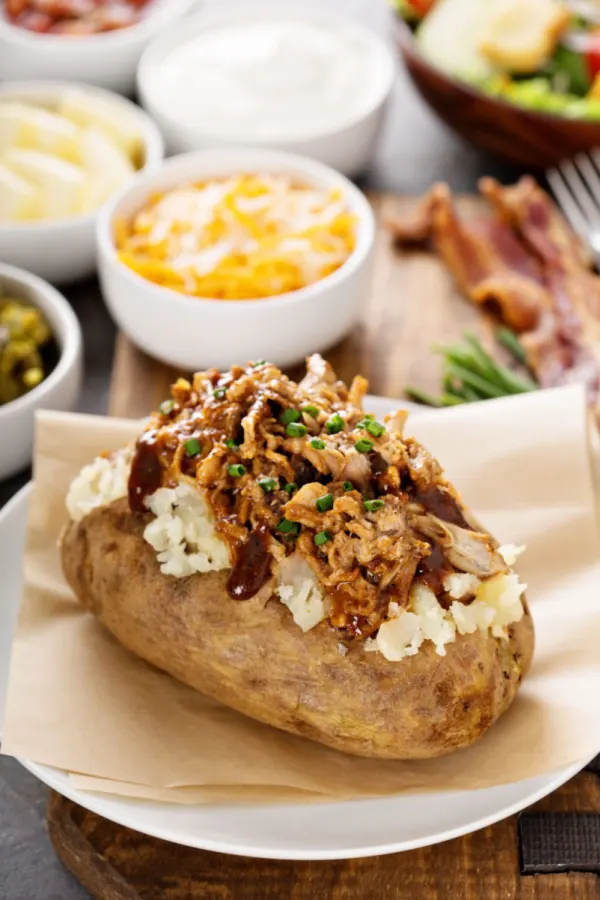 assembling pulled pork baked potatoes