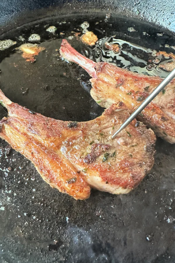 chops in skillet with thermometer in center