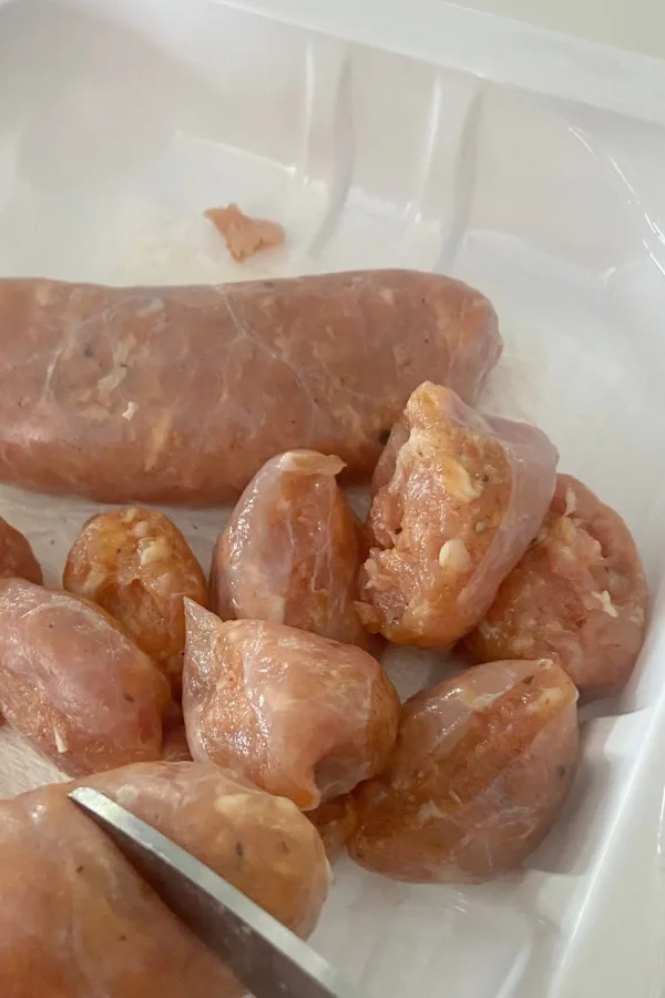 cutting sausage with scissors