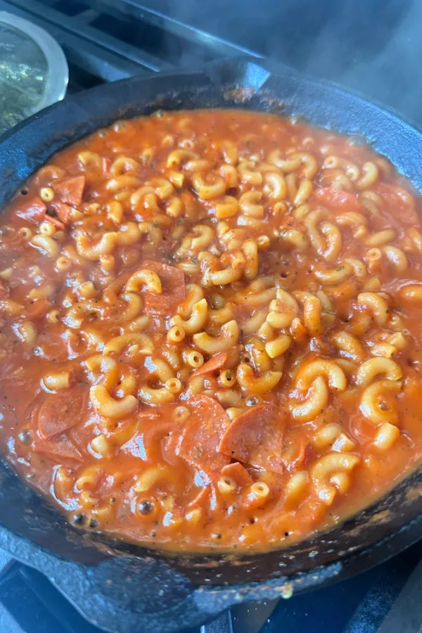 elbow macaroni noodles in a skillet in pizza sauce