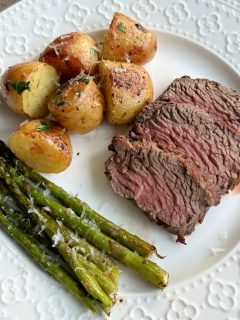 petite filet of beef and potatoes and asparagus