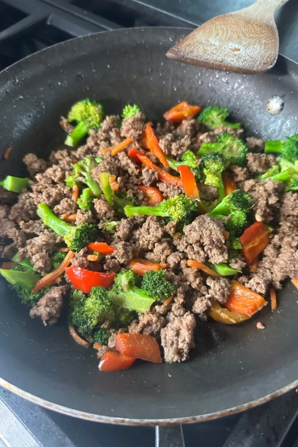 ground beef and vegetables in skillet 