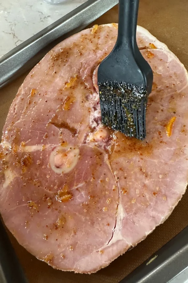 brushing glaze over meat