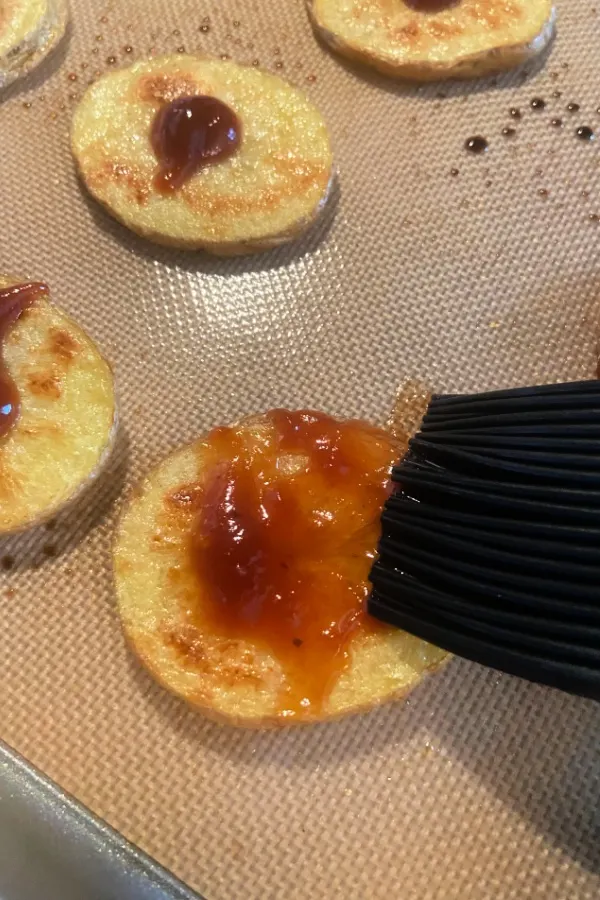 barbecue sauce on slices  of potatoes